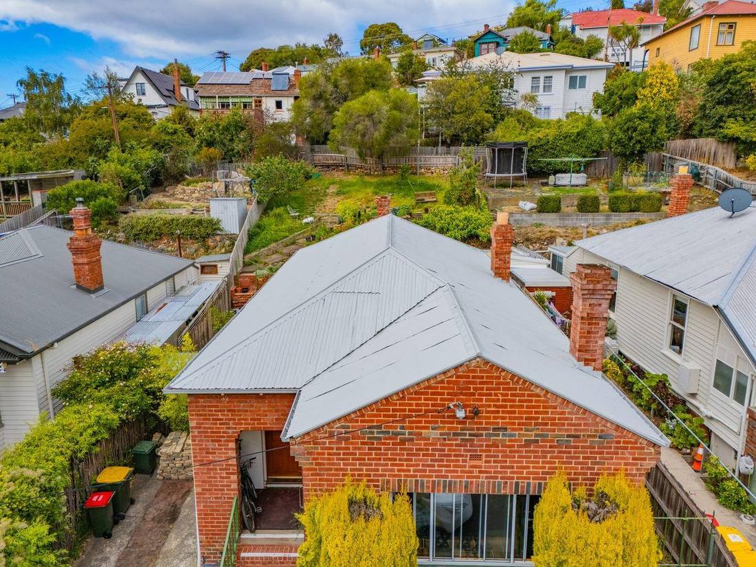 Brick cottage roof after cleaning, repair and re-coating
