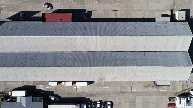Aerial view of a large freshly coated metal roof in Hobart