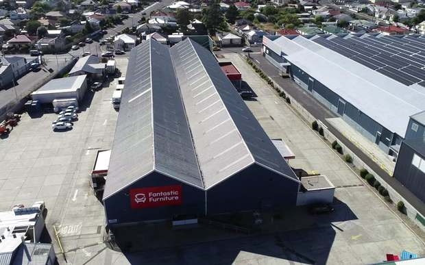 Large commercial warehouse roof coated in charcoal