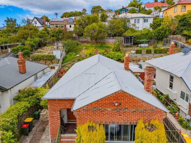 Brick cottage roof after cleaning, repair and re-coating