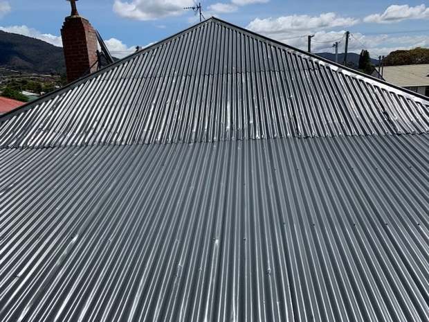 Corrugated iron — rust and patch repairs, out to charcoal after coating