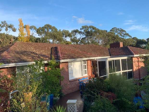 Tiled roof, moss and weathering before