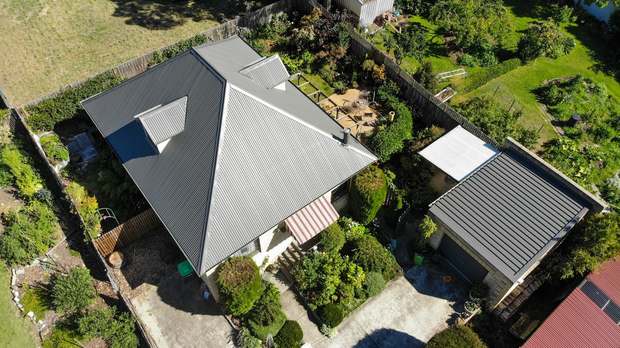 Patchy hip roof, finished in charcoal after coating