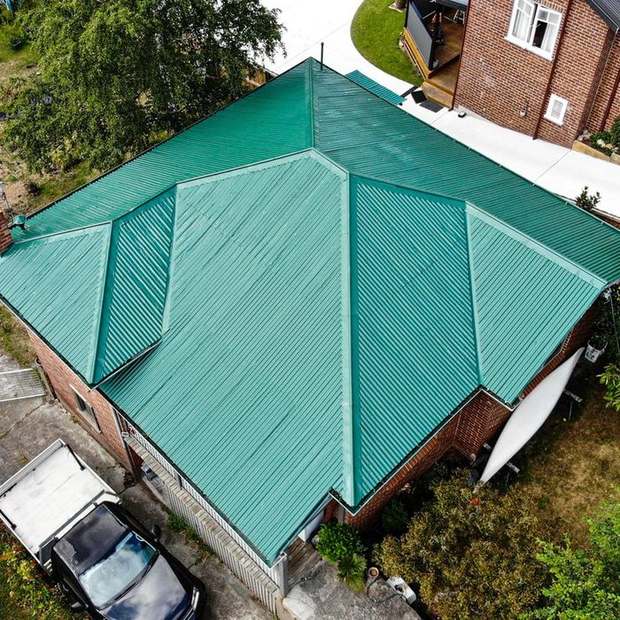 Corrugated roof recoated in green